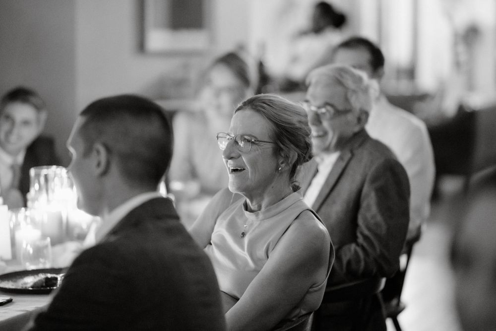 Black and white photo of guests seated at formal dinner tables during an event.