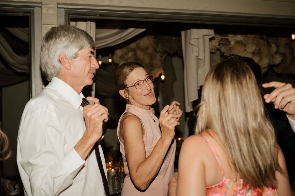 Guests dancing and celebrating during an indoor wedding reception.