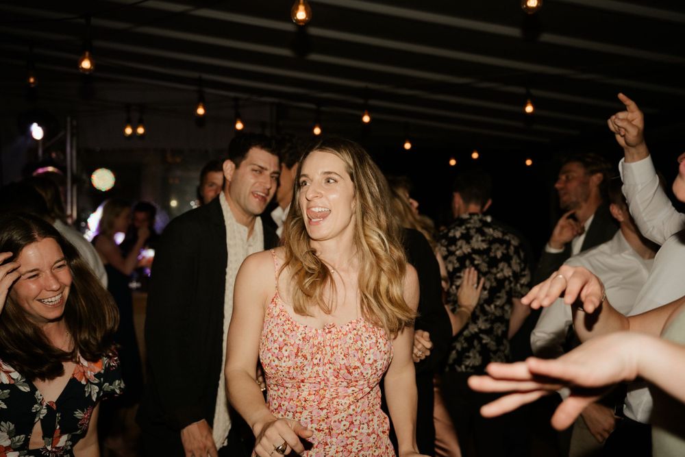 Lively dance floor moment at a wedding reception with guests enjoying the celebration.