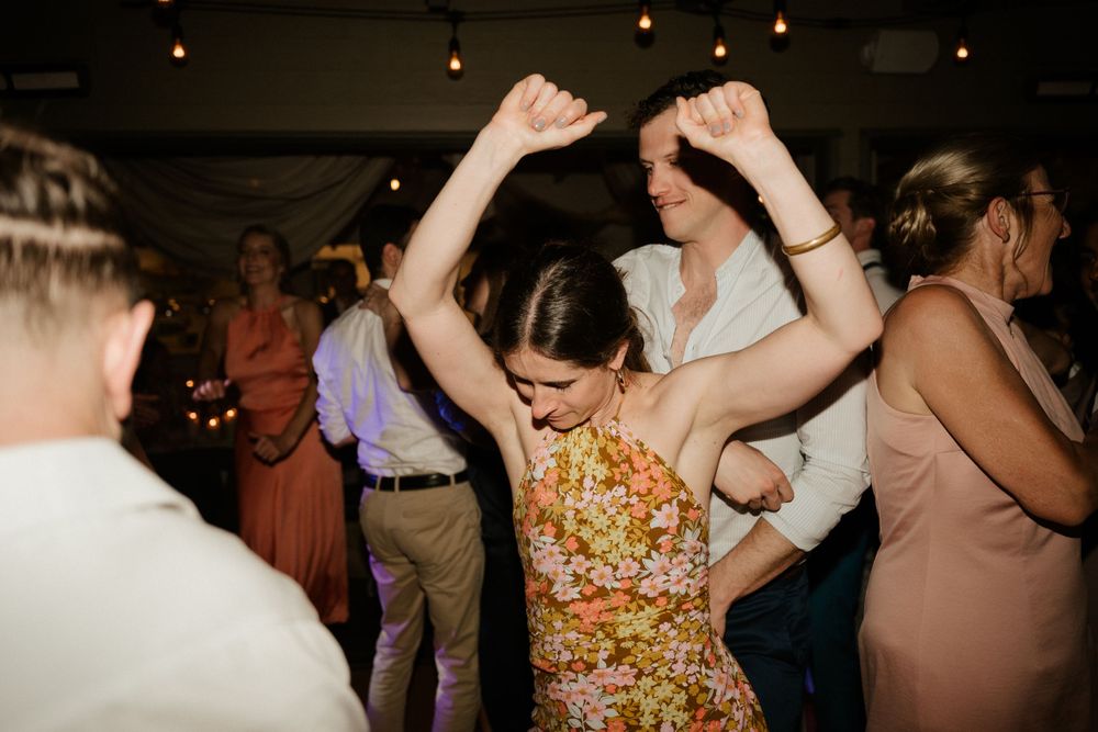 Joyful dancers enjoying themselves on the dance floor at a wedding reception.