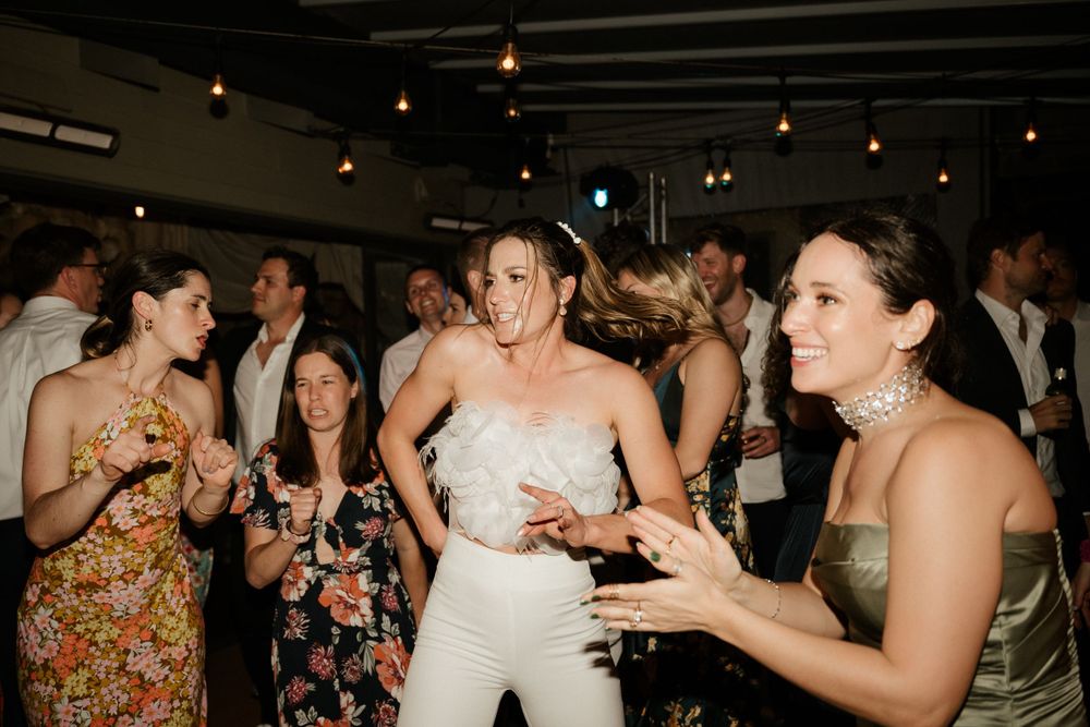 Guests dancing and celebrating at a lively wedding reception.