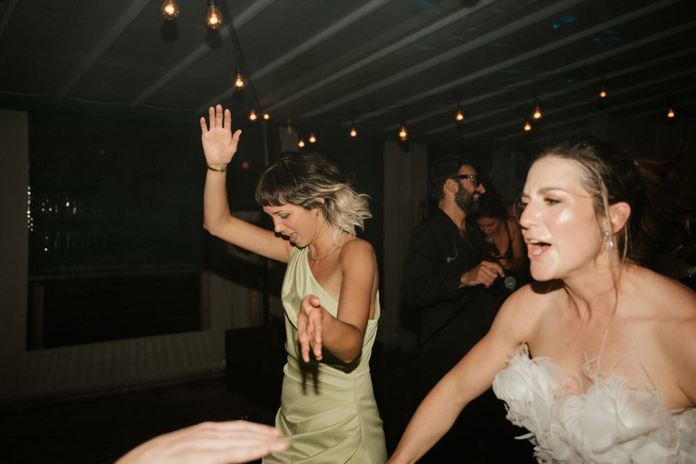 Guests enjoying themselves on the dance floor at a lively wedding reception.