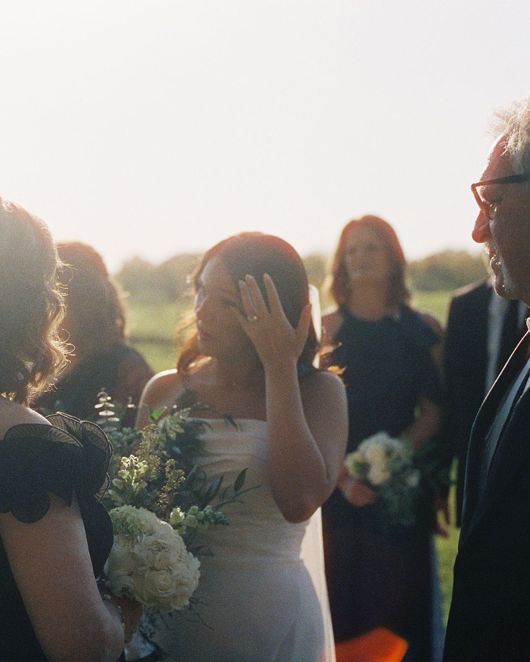 Couple sharing an intimate moment during sunset at their outdoor wedding ceremony.
