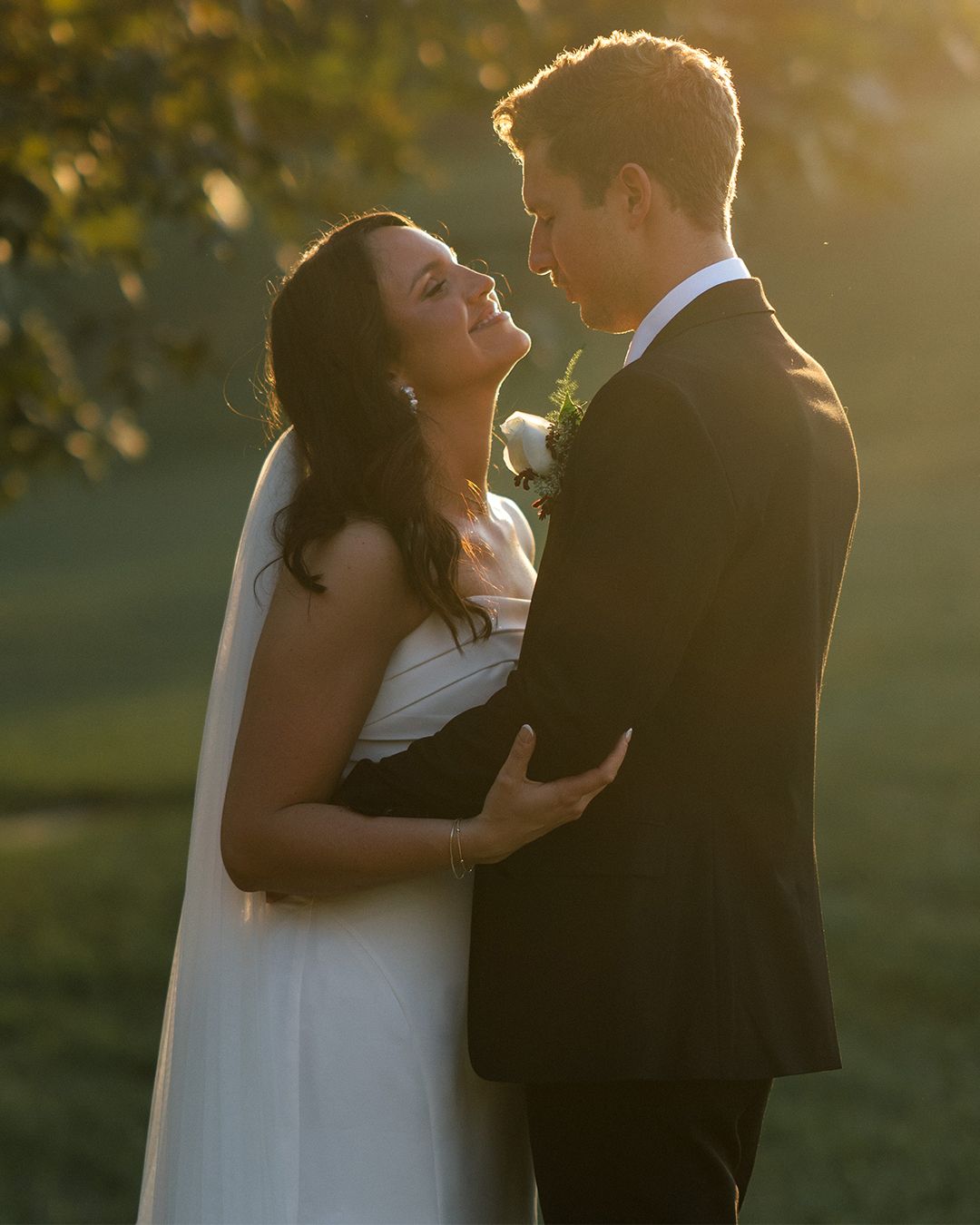 Golden hour wedding photography showing tender moments between newlyweds.