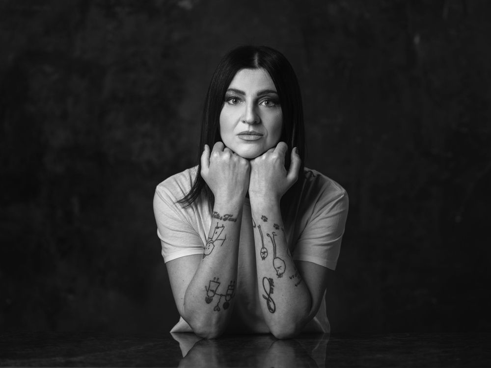 Dramatic black and white portrait series showing emotional expressions against dark background.