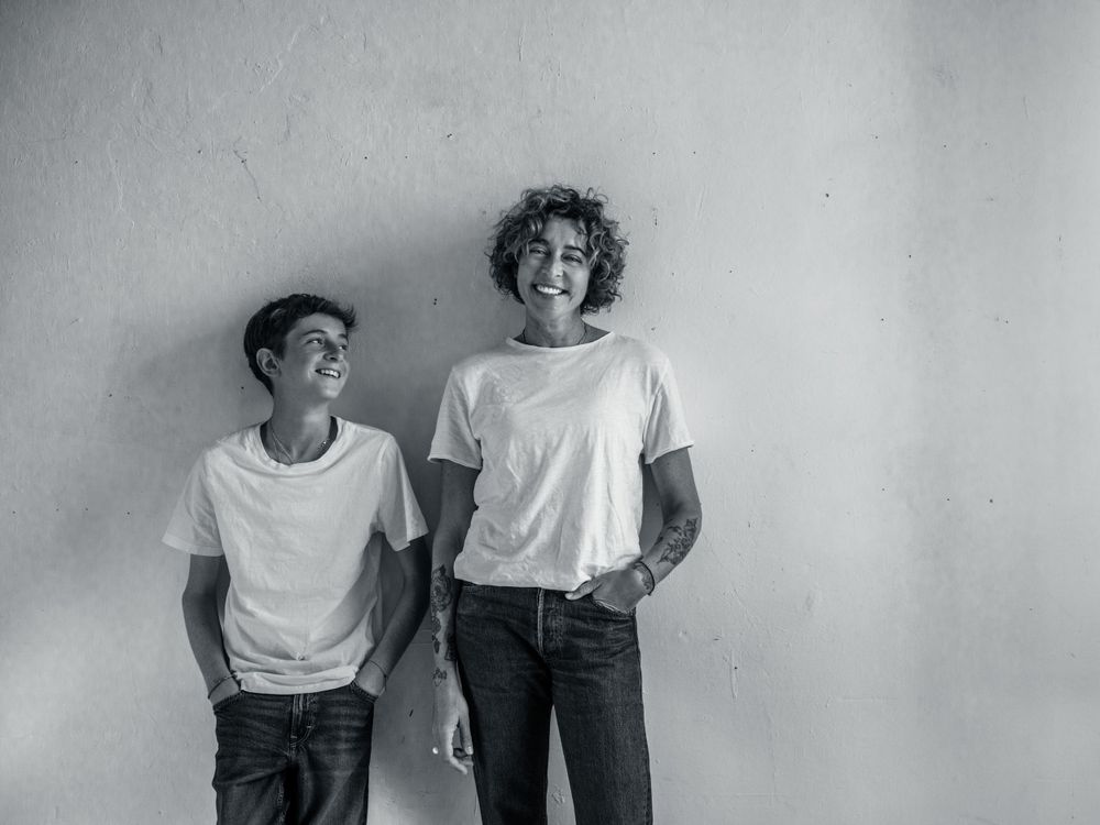 Black and white artistic portrait series showing playful interactions against a plain wall.