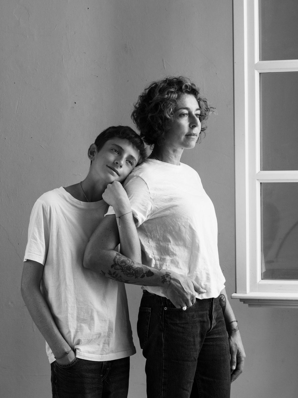Artistic black and white sequence showing casual interactions near a window.