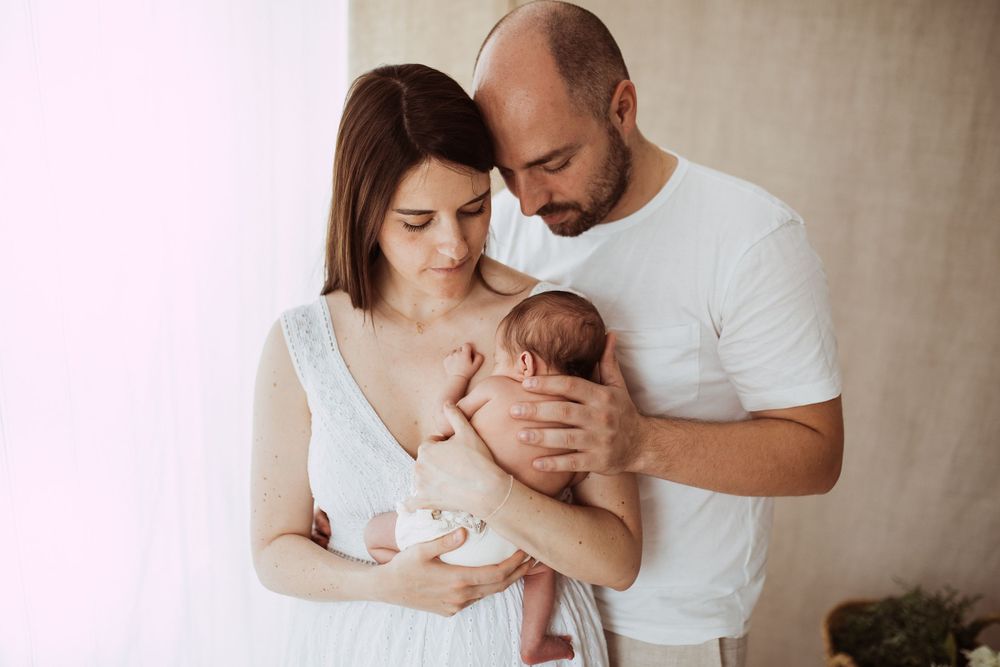 Family lifestyle portrait showing tender moments with newborn baby.