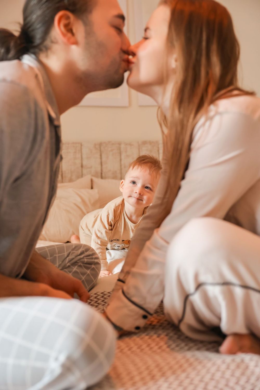 Sweet family moment shared on a cozy carpet in a sunlit room.