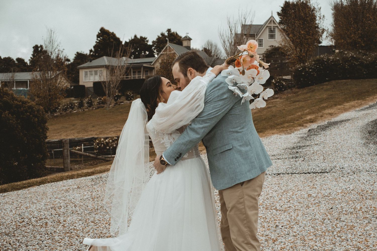 A romantic wedding photoshoot sequence showing couples embracing on a pebble beach at sunset.