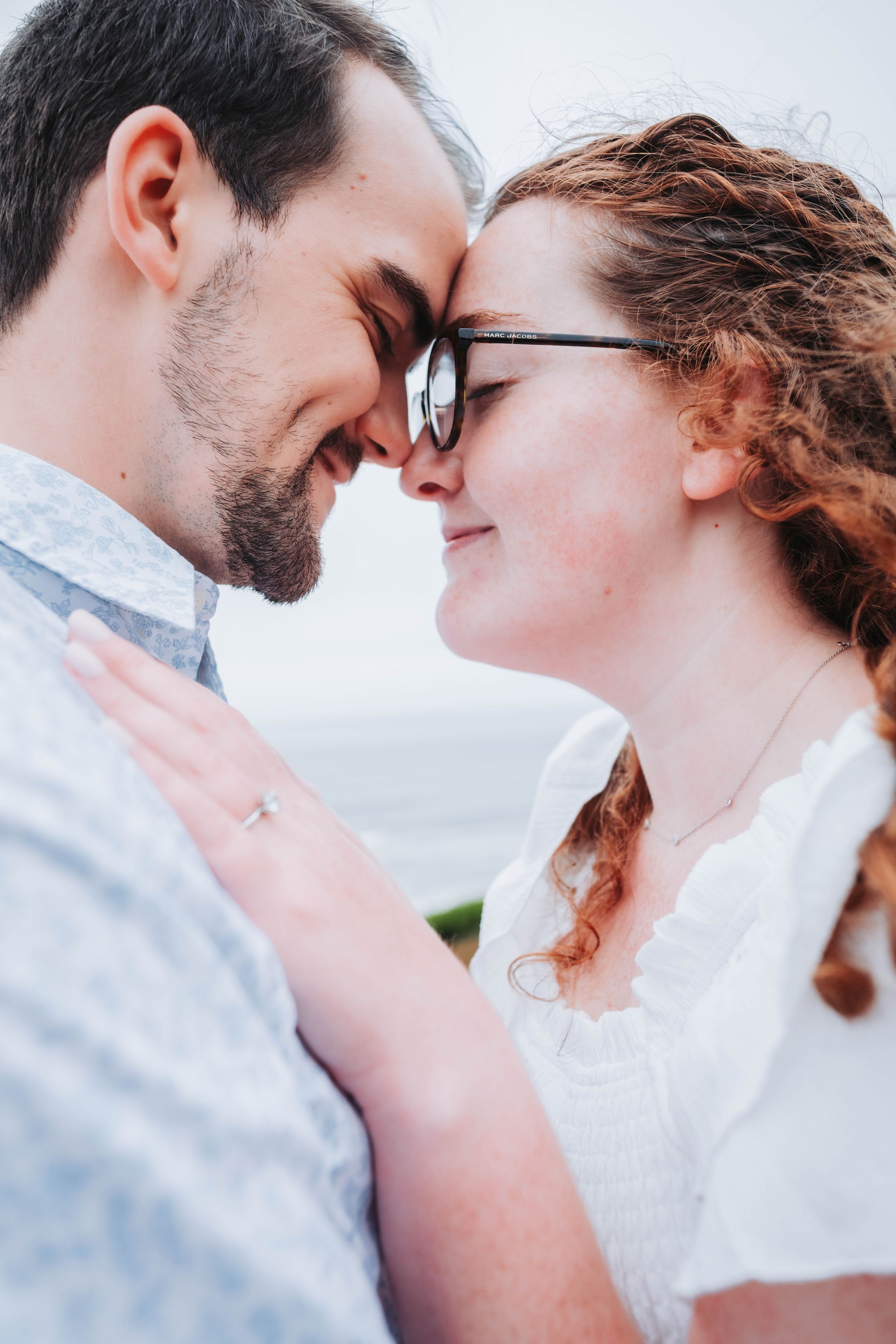 A romantic sequence of close-up shots showing a couple in white sharing intimate moments and tender gazes.