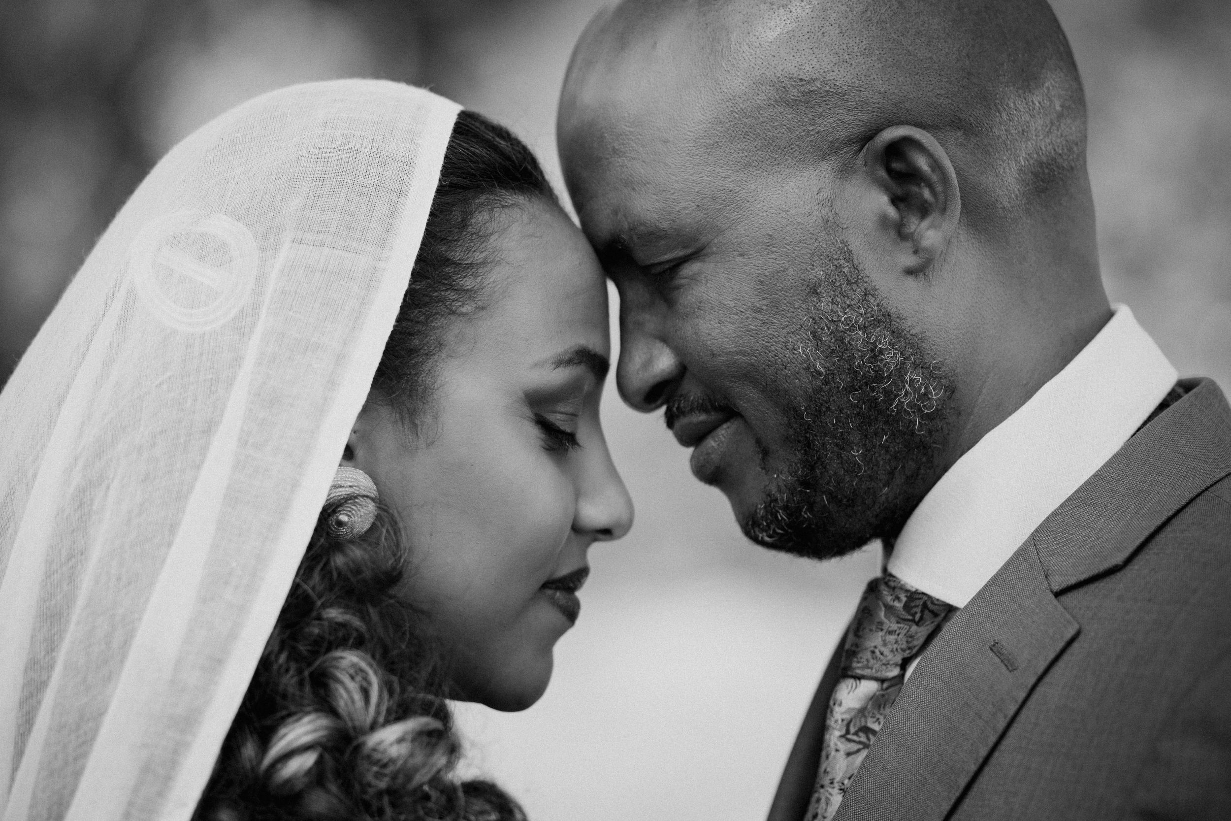 A romantic black and white photo collage showing tender moments between a couple on their wedding day.