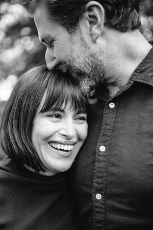 Black and white photo series showing a couple sharing intimate moments and laughter together.