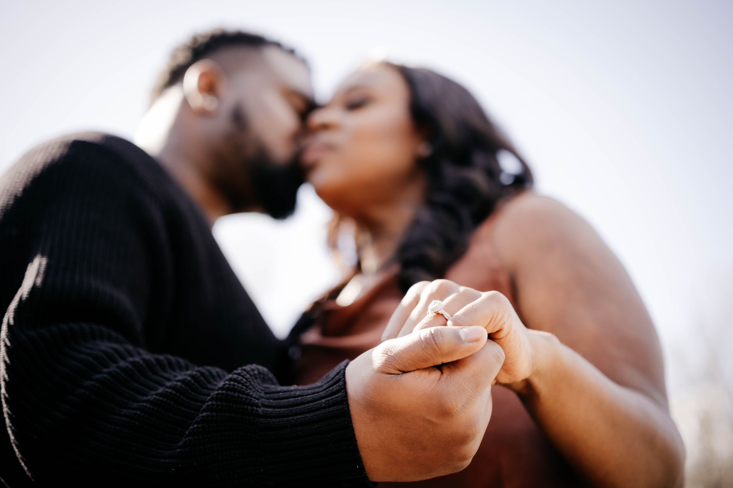 A couple shares an intimate romantic moment together in a soft, dreamy light setting.