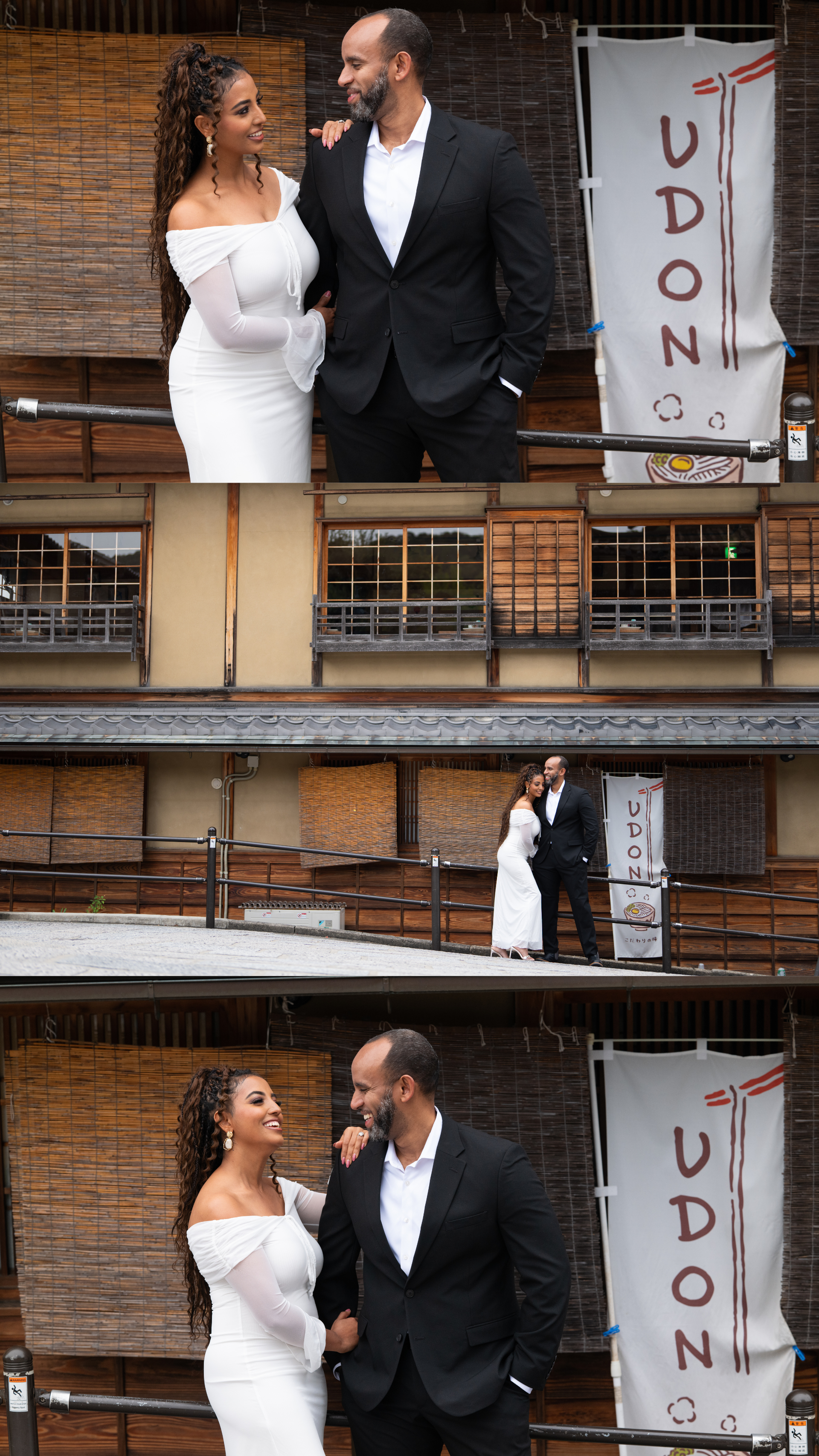 Couple poses and laughs together on a Japanese street beside a traditional UDON restaurant banner in Kyoto.