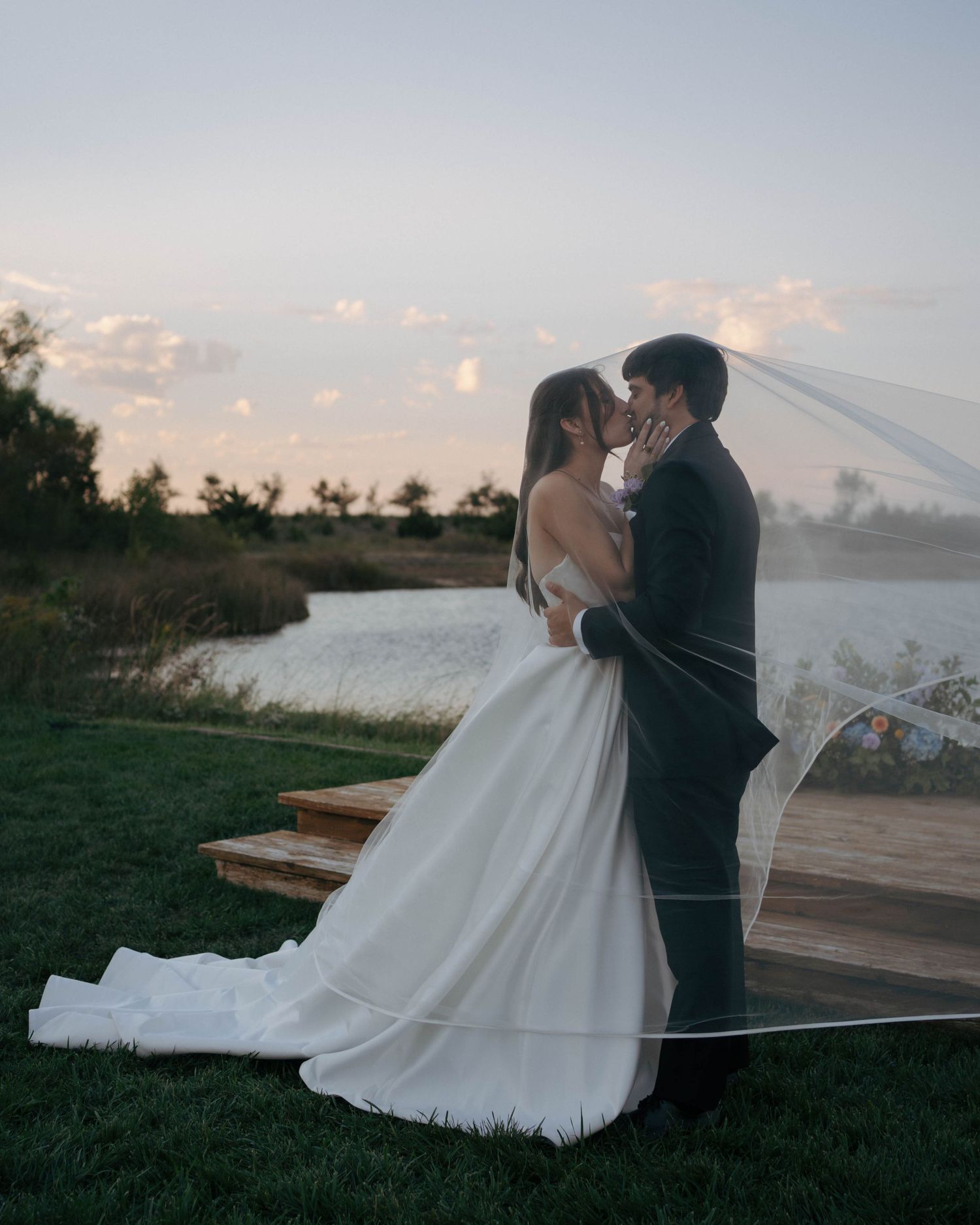 A couple shares an intimate moment at sunset as the bride's veil flows dramatically in the wind across multiple frames.