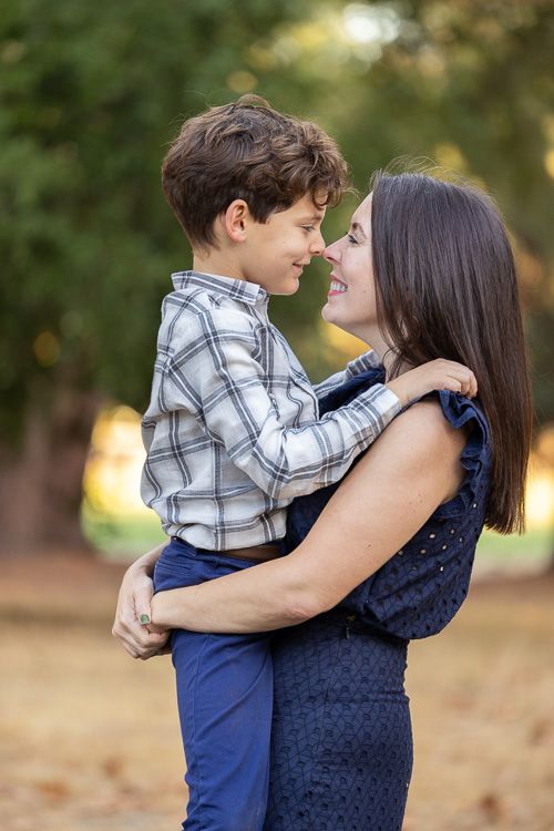 A mother and young son share a playful embrace and tender moment in the Bay Area