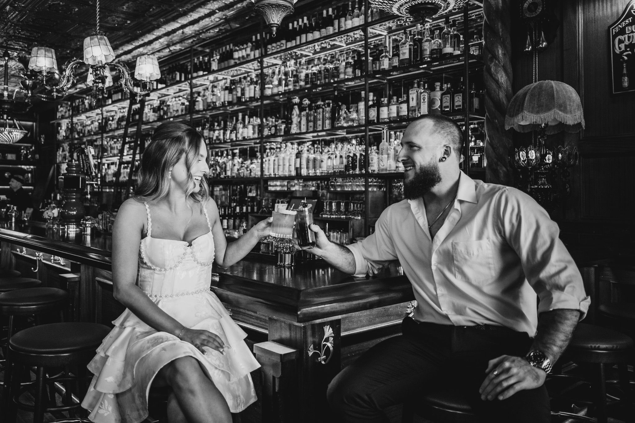 Intimate bar photoshoot with moody lighting and classic cocktail ambiance.