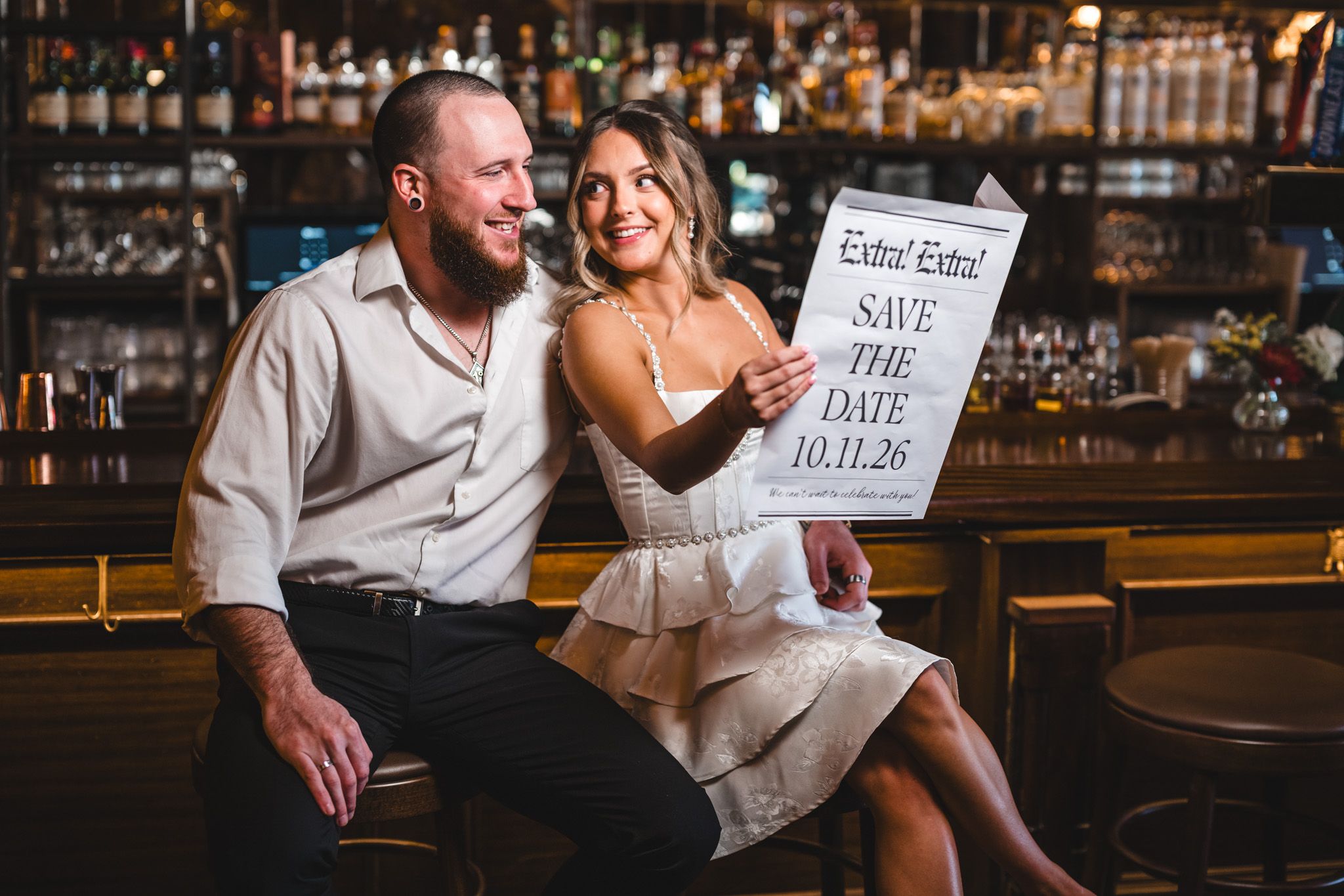 Couple enjoying drinks and conversation at a sophisticated bar setting.