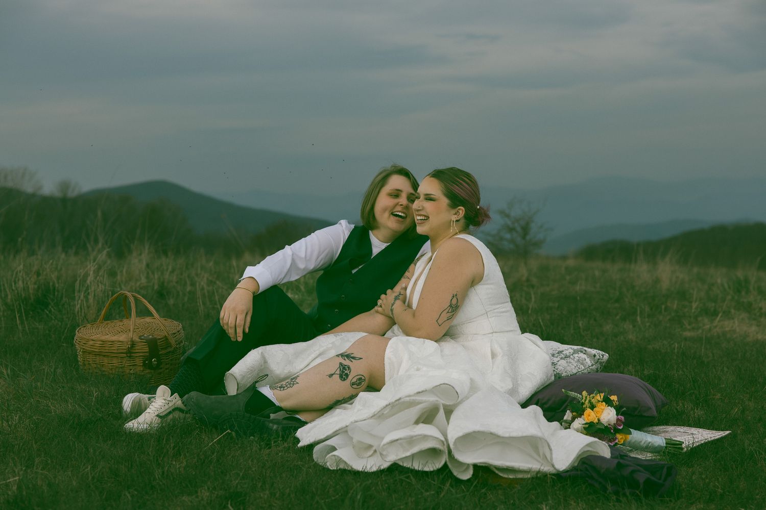 LGBTQ couple holding hands after romantic elopement at blue ridge mountain overlook near Asheville, North Carolina