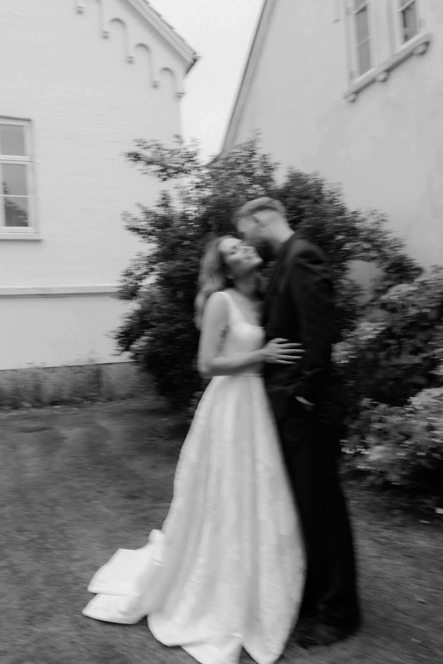 A vintage-inspired wedding portrait with the bride wearing a chic pillbox veil and holding a white bouquet.