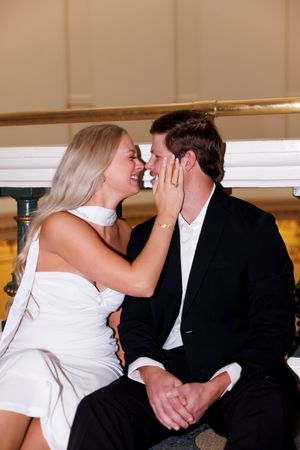 A tender embrace between newlyweds in an elegant indoor setting.