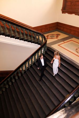 Elegant staircase photo series showing couple descending steps.