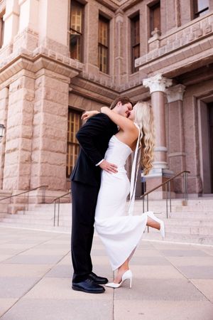 Romantic dance dip sequence on stone plaza.