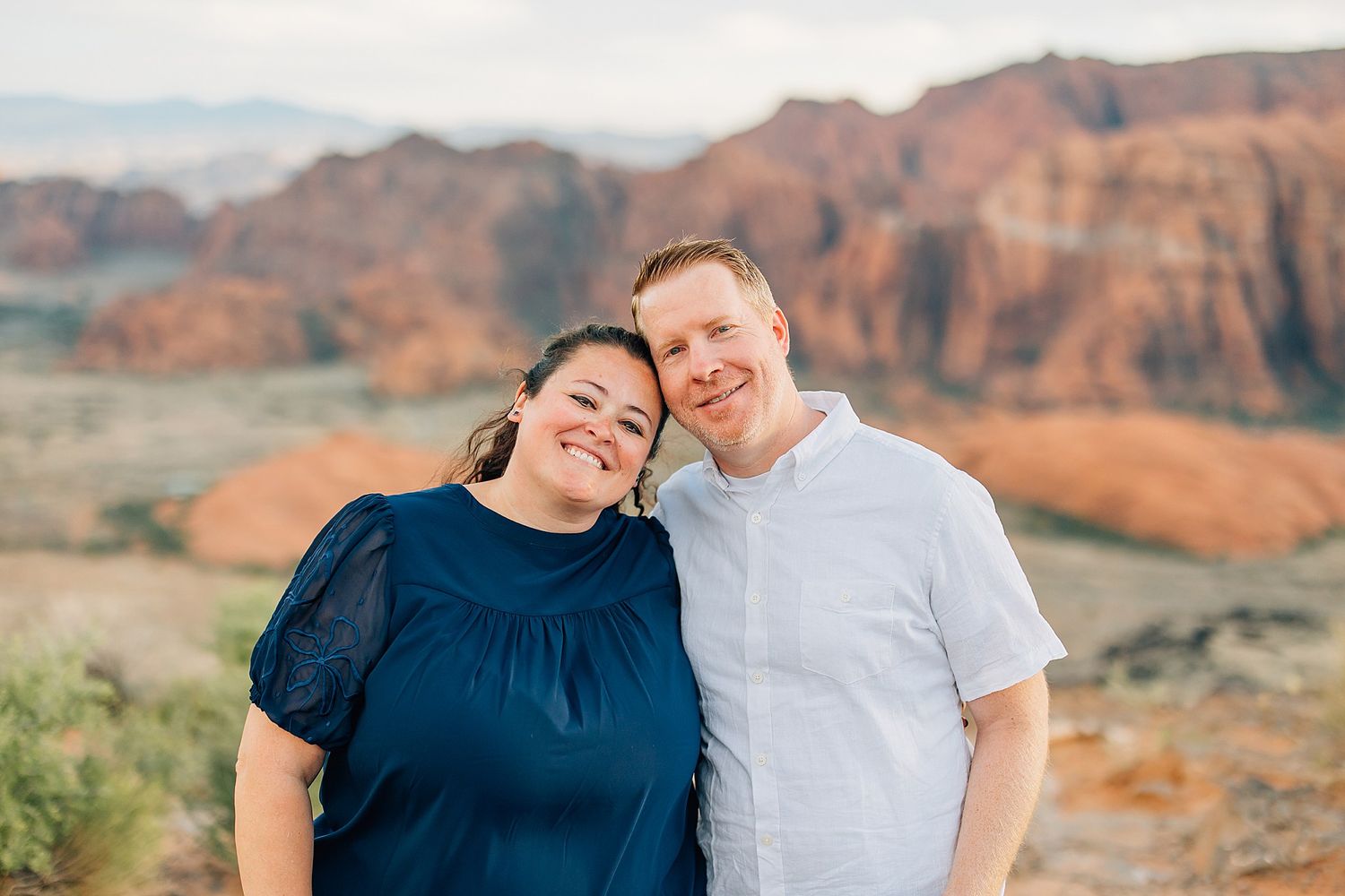Intimate family moments photographed with dramatic desert cliffs in the background.