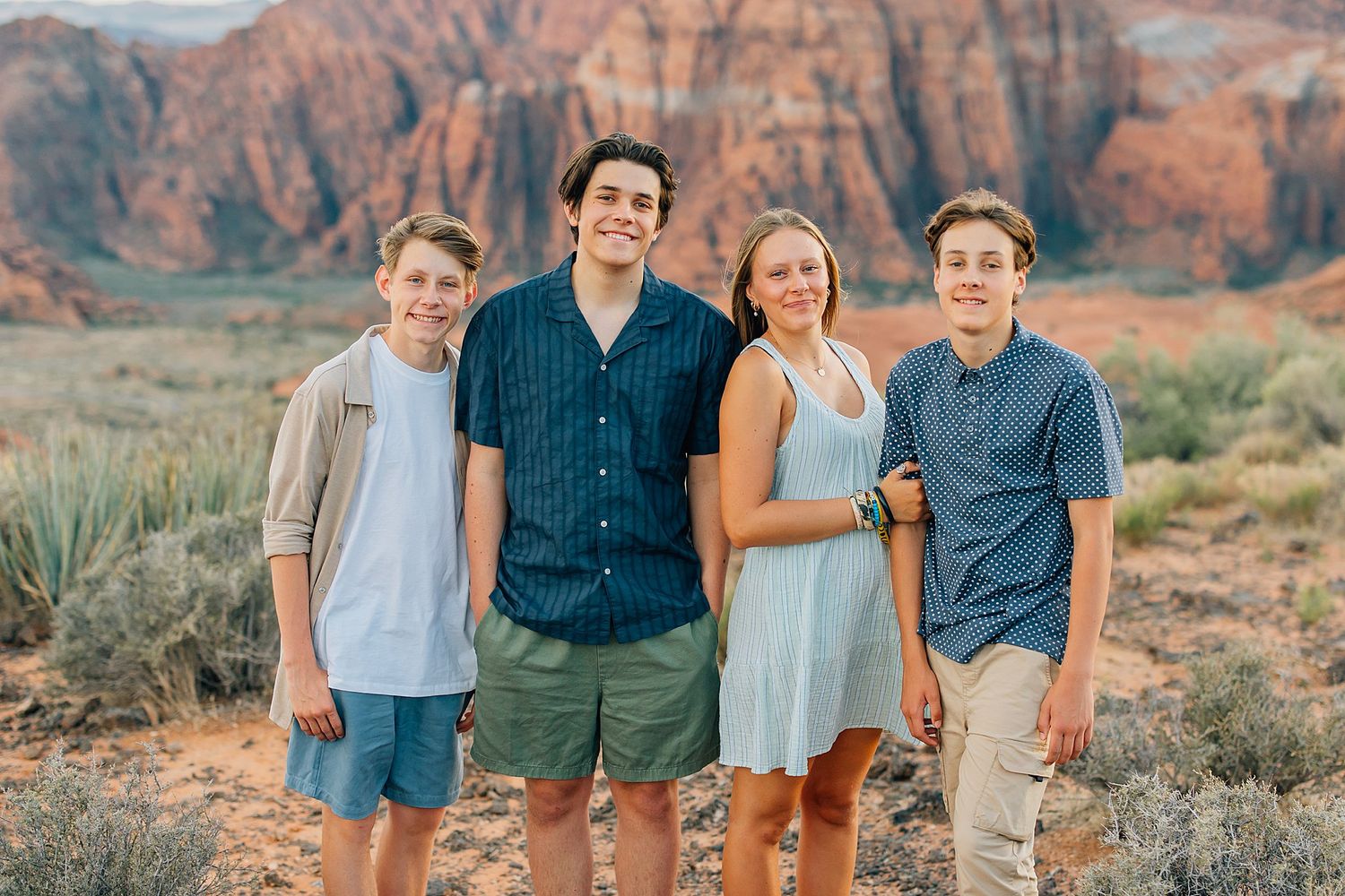 Casual outdoor portrait session with majestic red rock formations in Snow Canyon State Park.