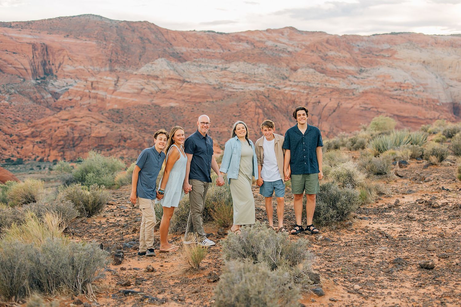 People gathered for photos with sweeping views of Utah's dramatic red rock landscape.