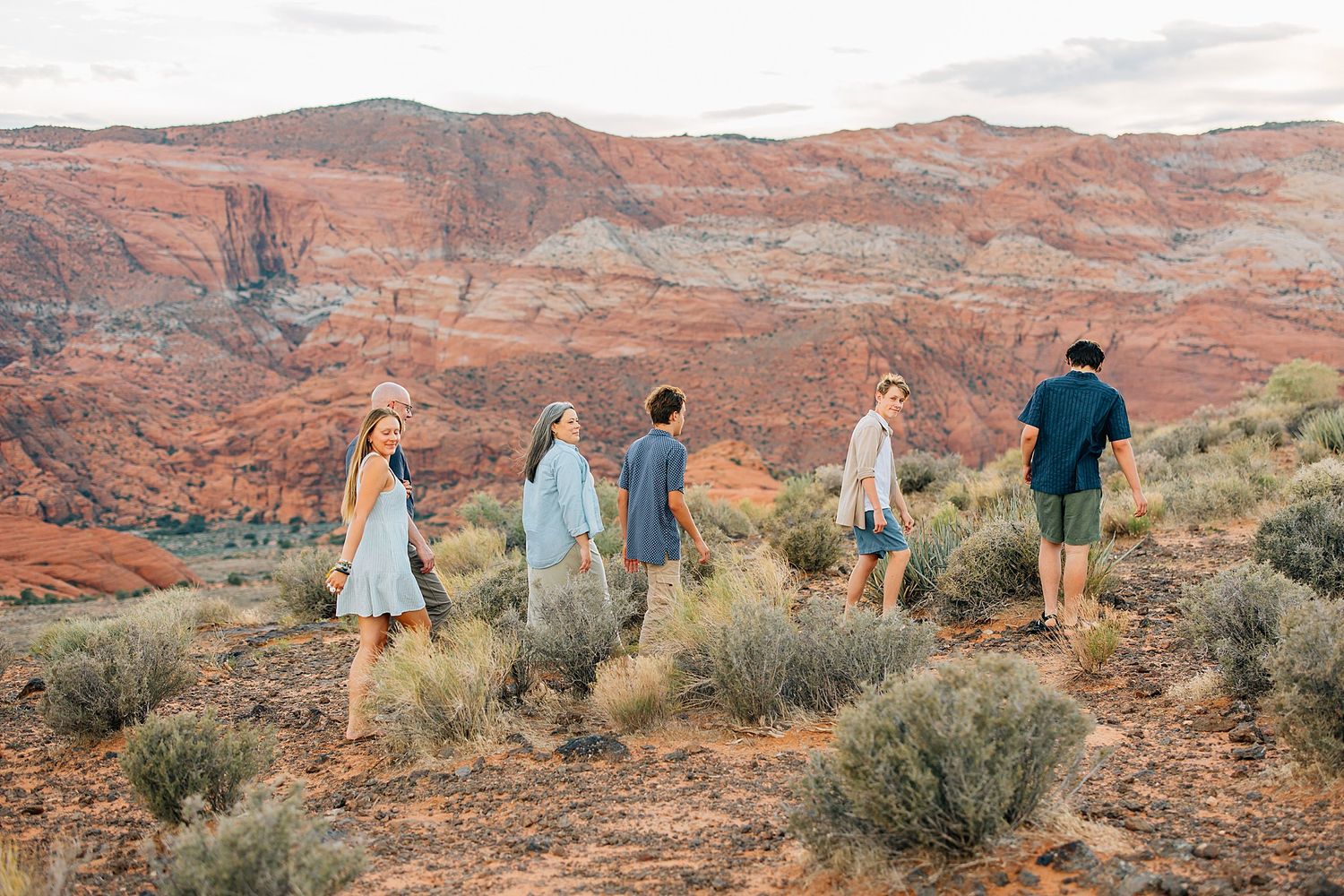 Candid moments captured against the backdrop of Utah's iconic red rock cliffs.