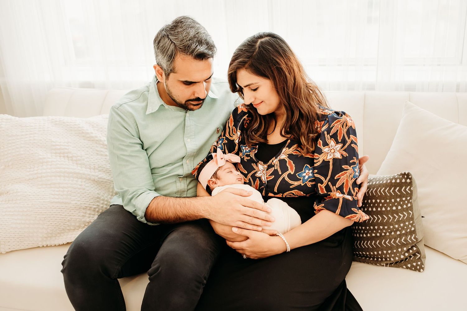 Mom holding newborn baby during a cozy studio session in Cincinnati.