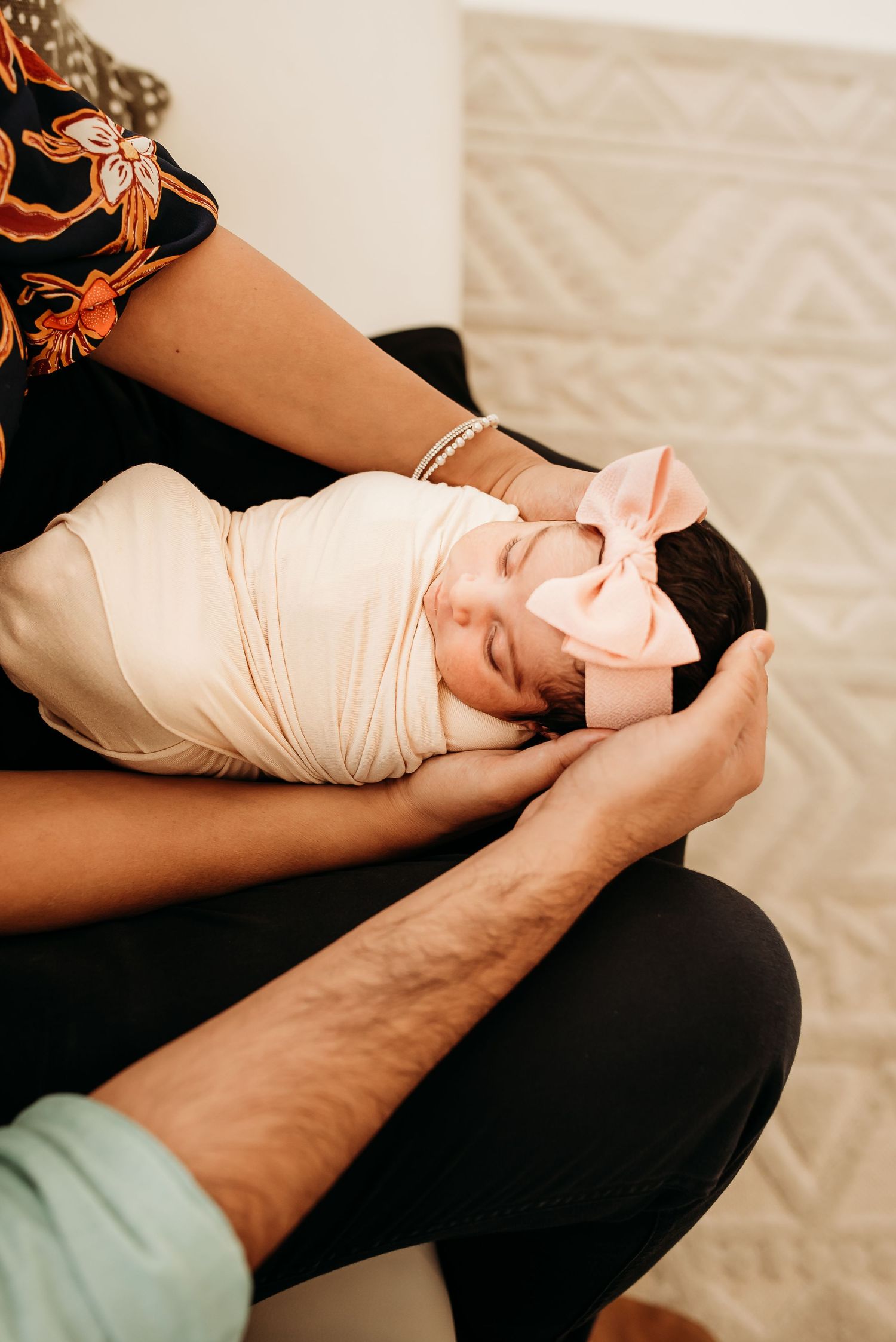Mom holding newborn baby during a cozy studio session in Cincinnati.
