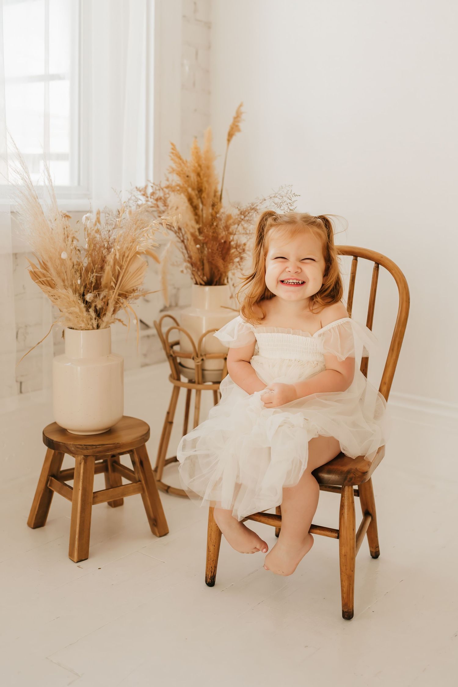 Lifestyle family portrait in a bright Cincinnati photography studio with natural light and neutral décor.