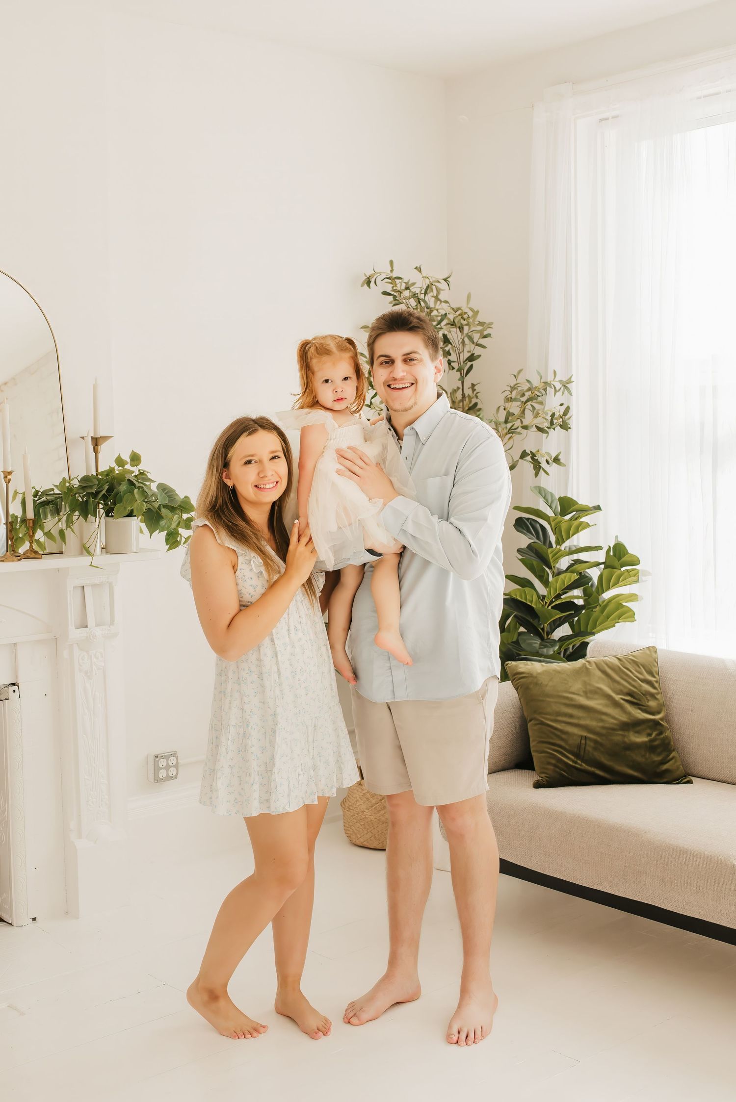 Lifestyle family portrait in a bright Cincinnati photography studio with natural light and neutral décor.