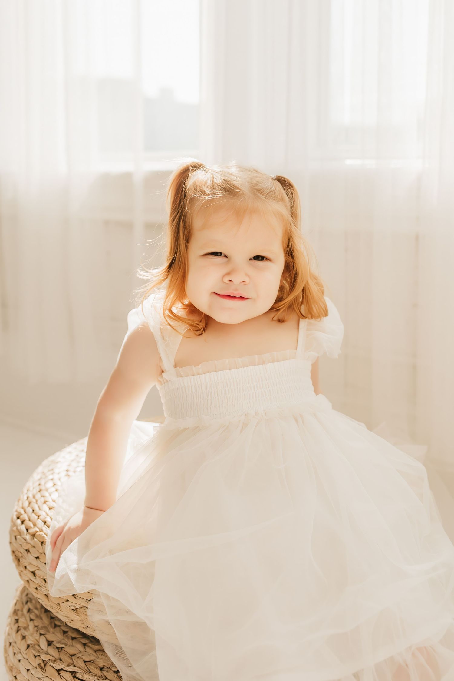 Lifestyle family portrait in a bright Cincinnati photography studio with natural light and neutral décor.