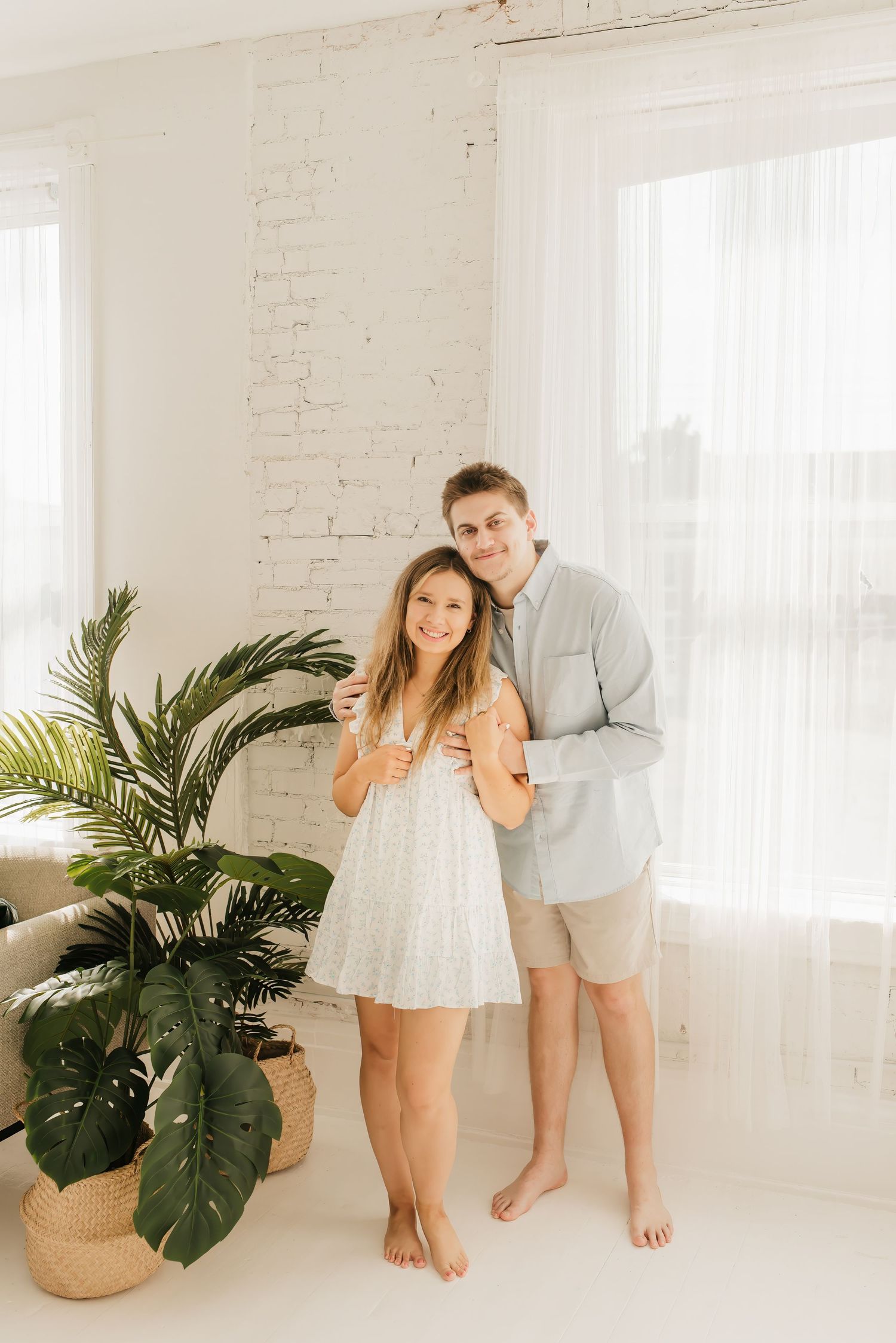 Lifestyle family portrait in a bright Cincinnati photography studio with natural light and neutral décor.