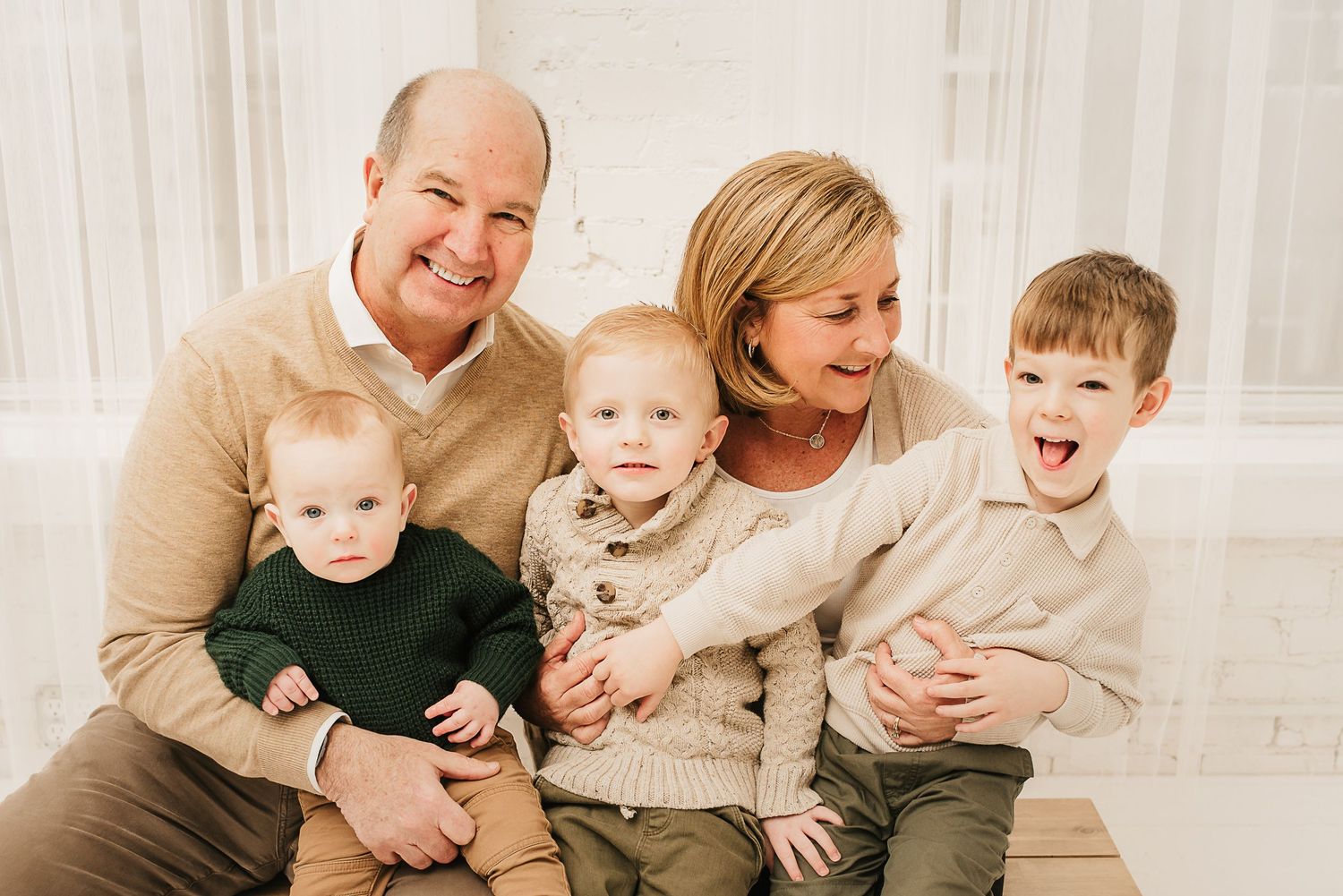 Playful family moment captured in a natural-light Cincinnati photography studio.