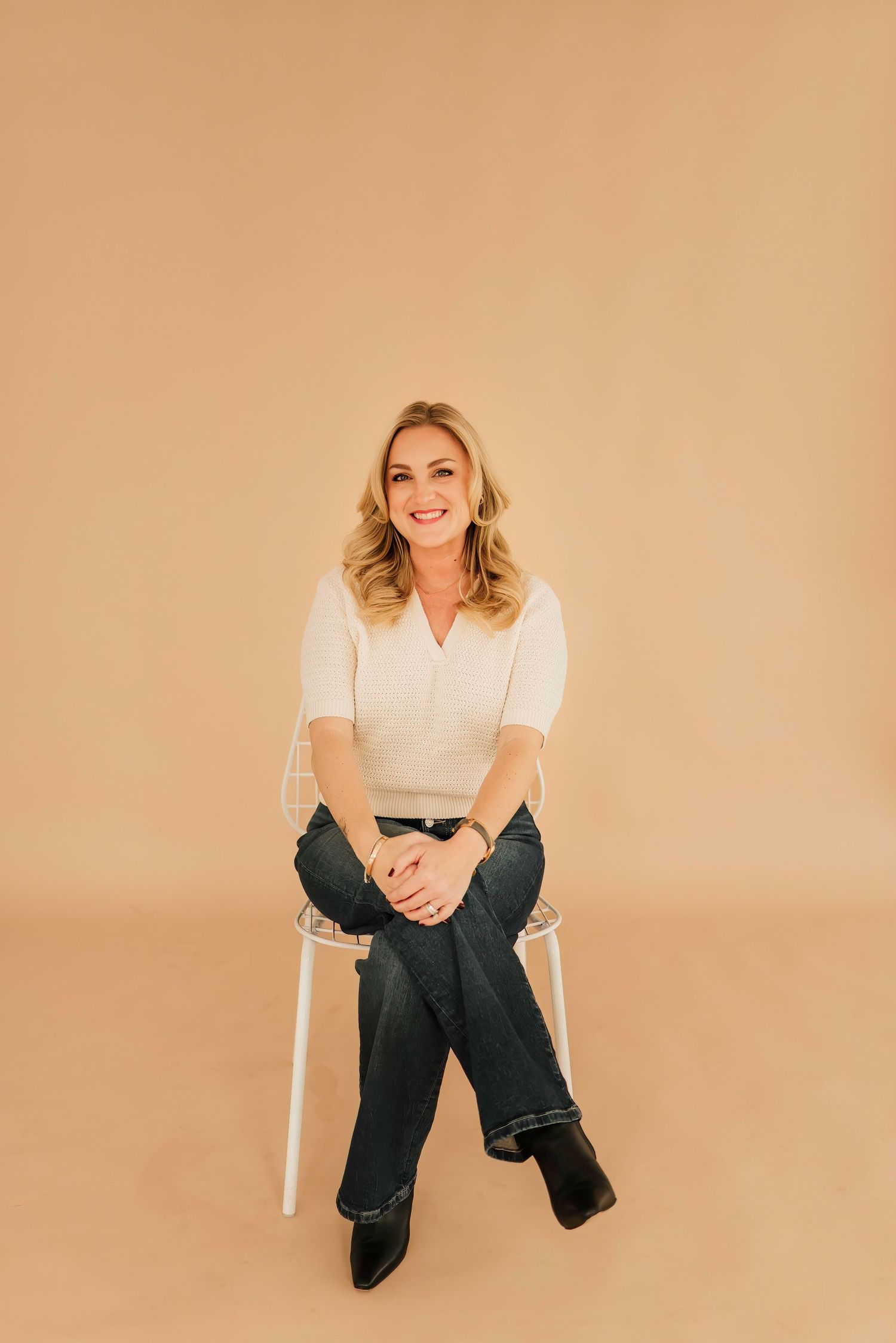Studio headshot in natural-light Cincinnati space with soft, neutral background.