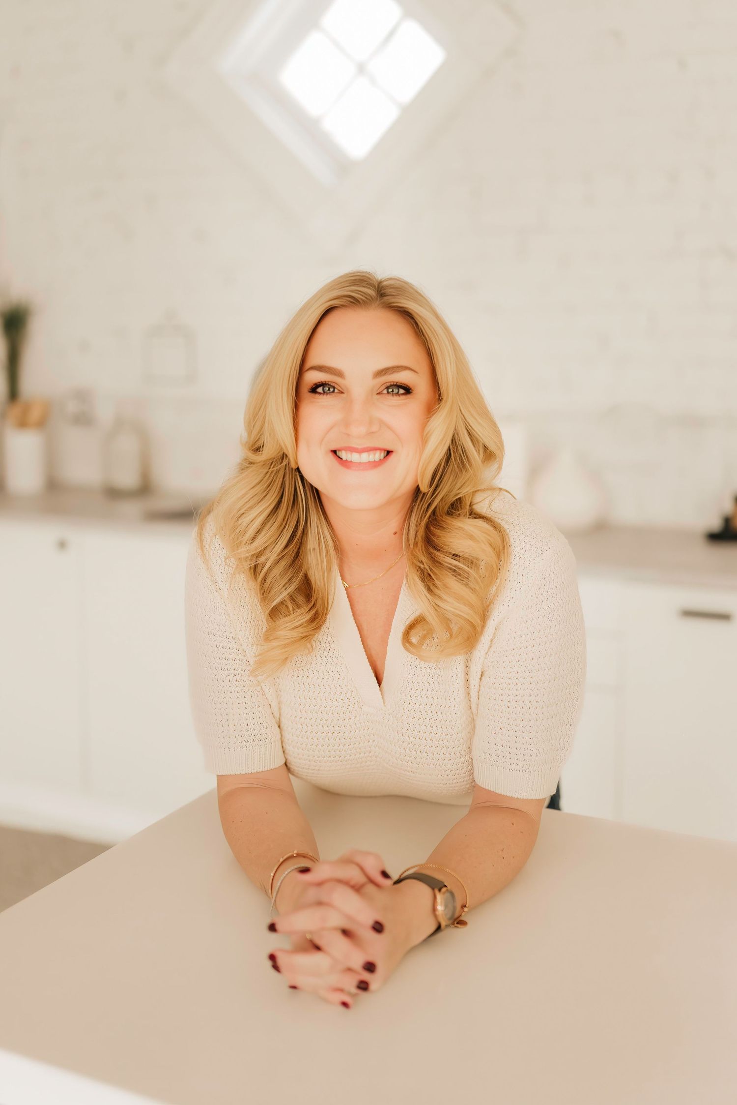 Studio headshot in natural-light Cincinnati space with soft, neutral background.