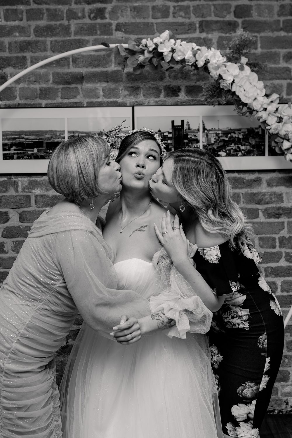 A sequence of romantic wedding photos showing a couple sharing intimate kisses against a brick wall backdrop.