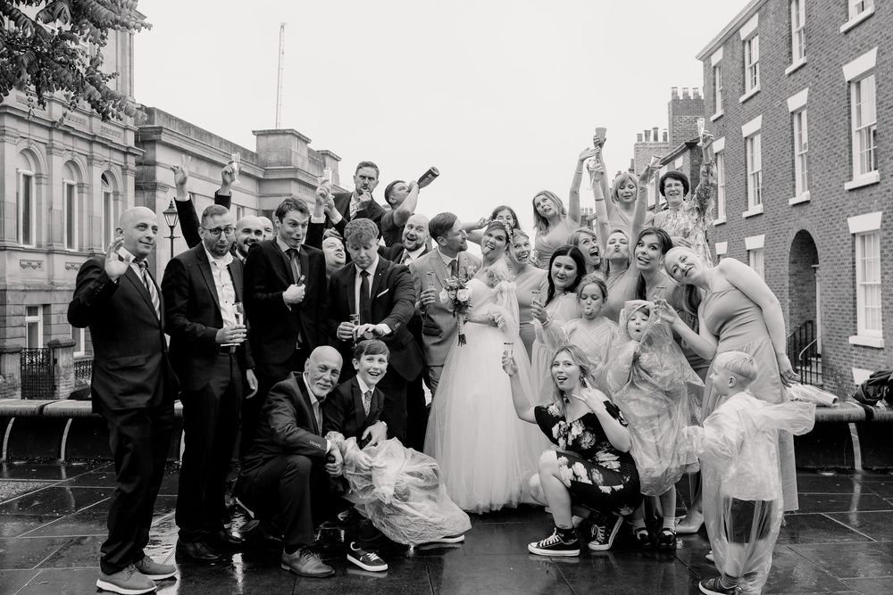 A series of black and white photographs showing wedding celebrations and group gatherings outside brick buildings.