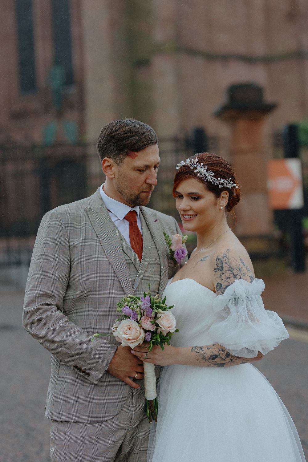 Romantic wedding portraits showing tender moments between couple in grey suit and white dress.