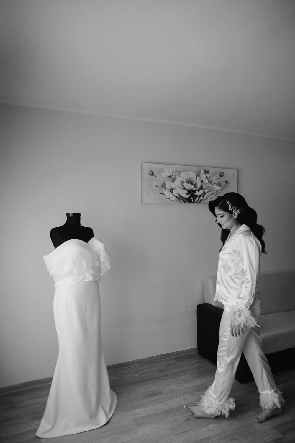 A series of black and white photos showing abstract movements with flowing white fabric in an empty room.