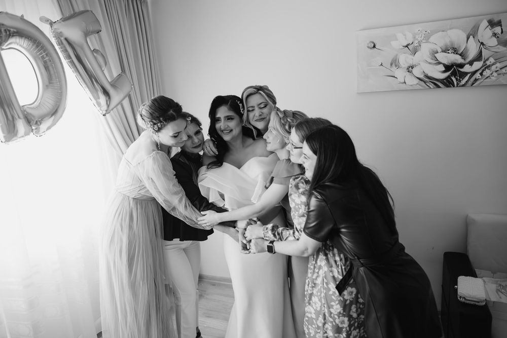 A series of black and white photos showing preparations and candid moments during a wedding celebration.