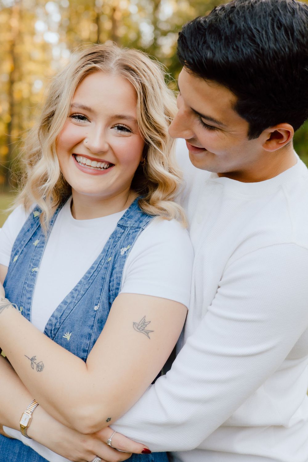 A couple in white shirts and denim share intimate moments in a series of romantic outdoor photos.