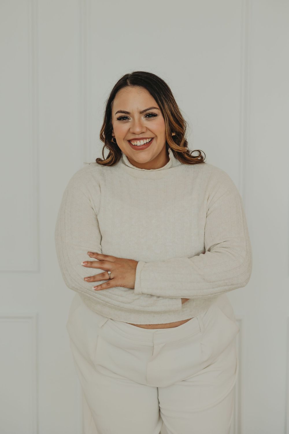 A person wearing a cozy cream-colored sweater poses against a white background in a series of casual shots.