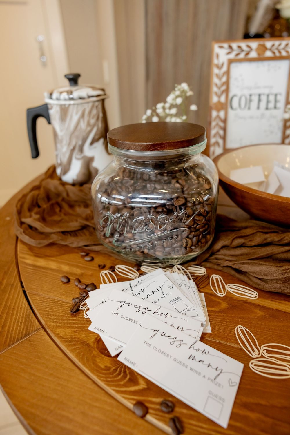 Glass mason jar filled with coffee beans for a bridal shower game to guess the coffee beans,