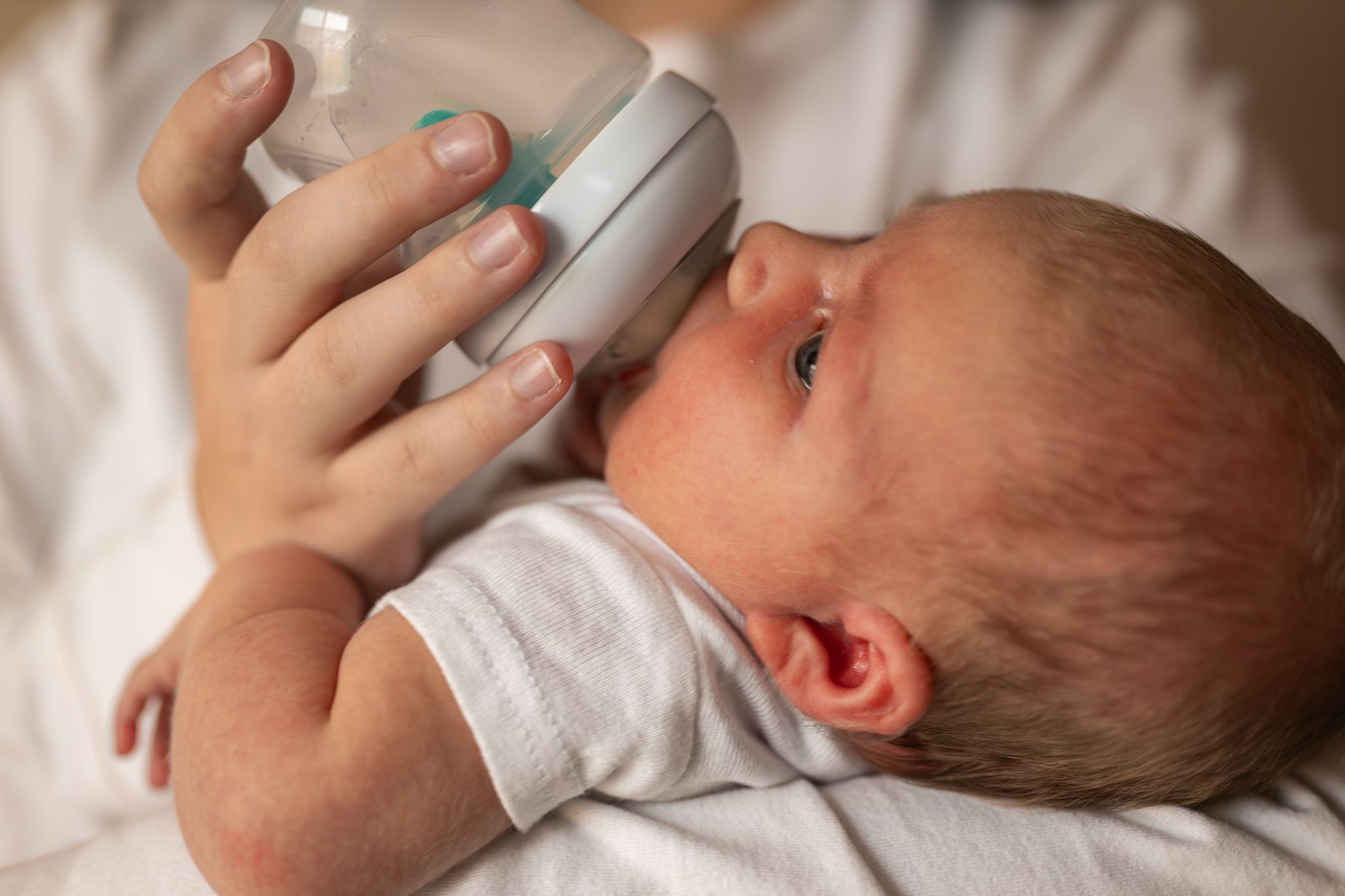 A baby drinking a bottle.
